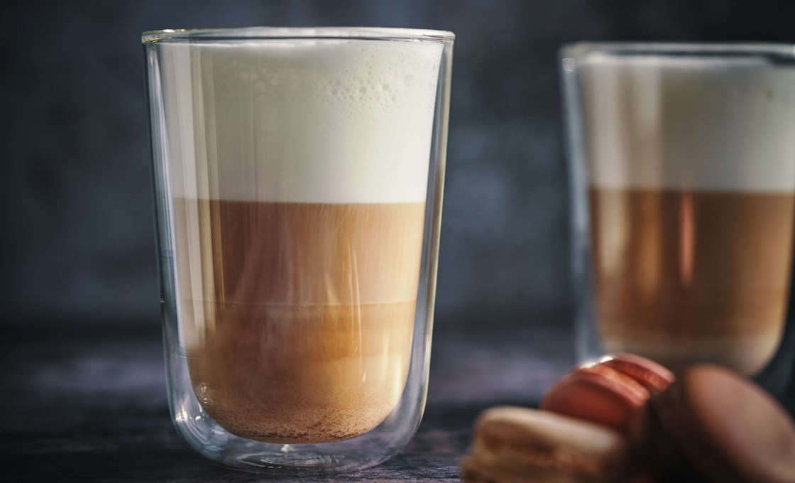 Two glasses of hazelnut cappuccino with macarons