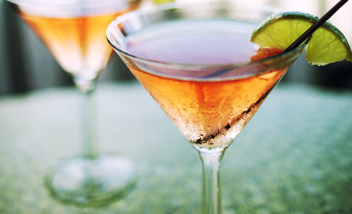 Two glasses of Watermelon Martini on a green table