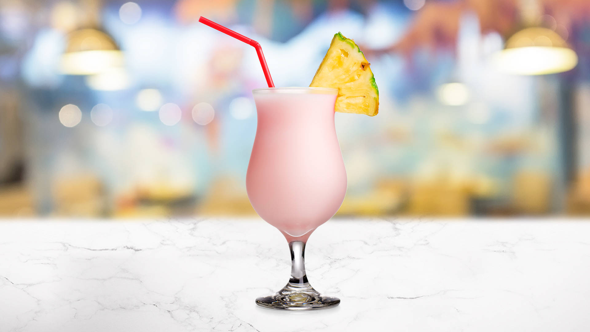 Glass of Lime & Pink Grapefruit Smoothie garnished with pineapple