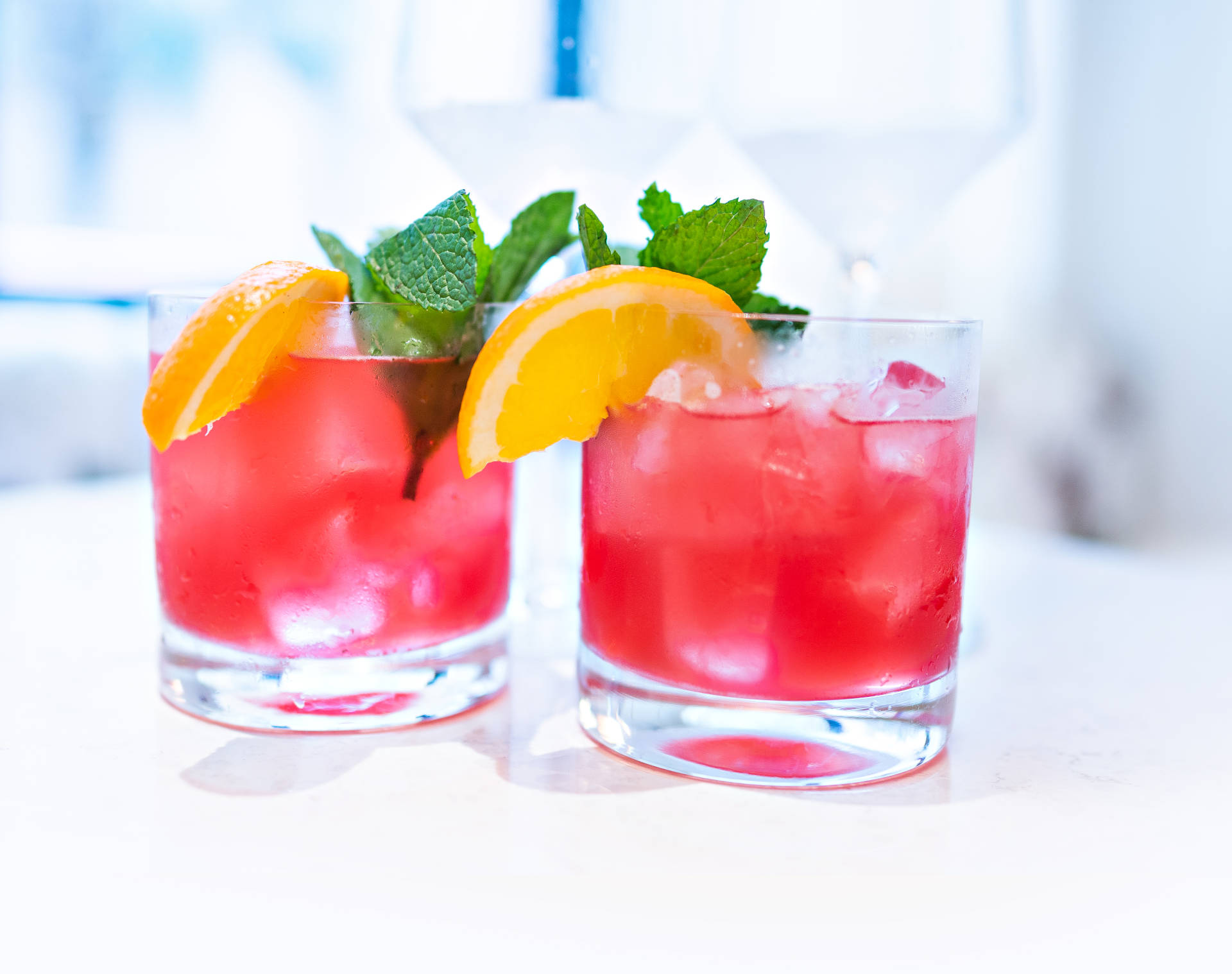 Two glasses of Pinky with lemon garnish