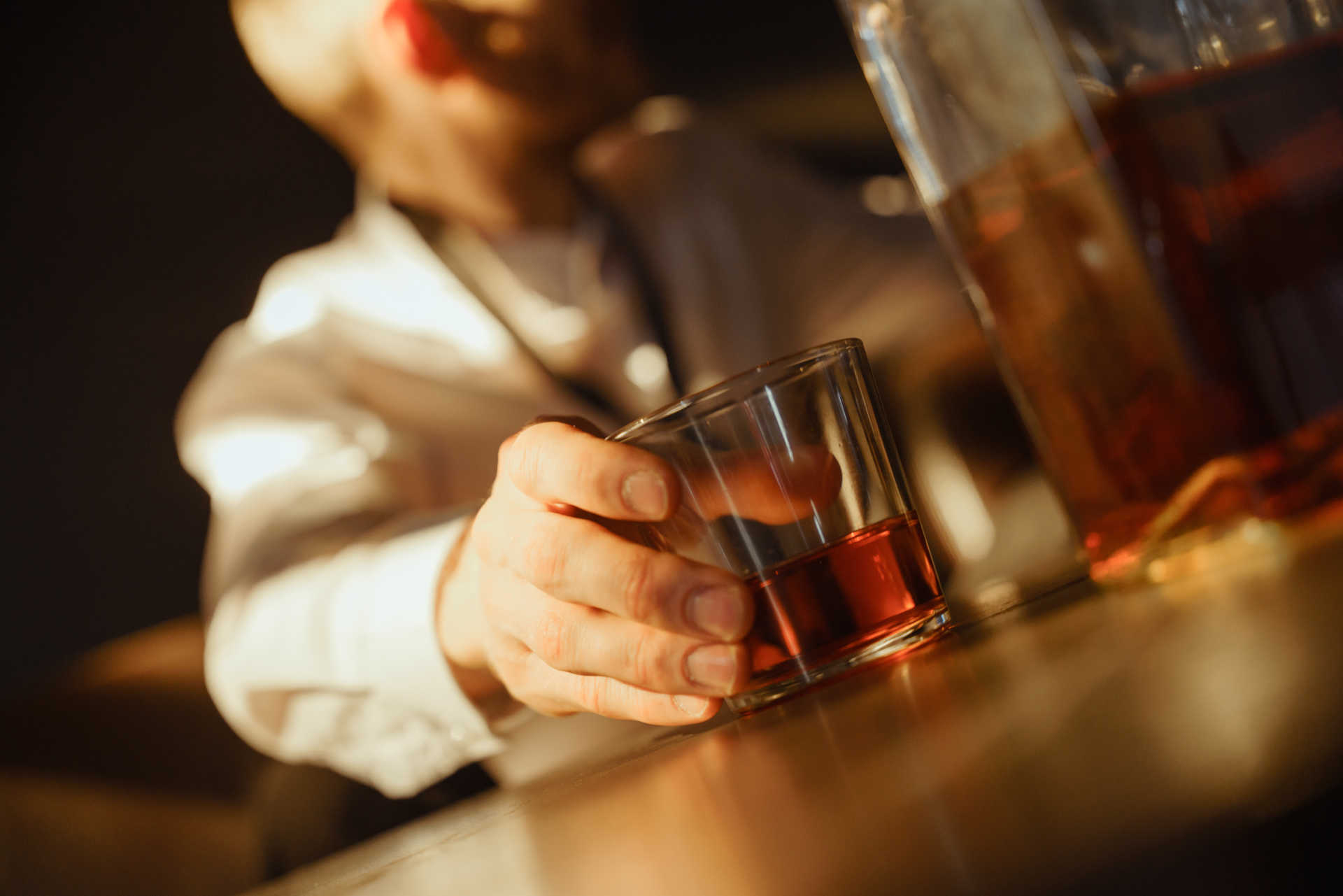 bartender placing a glass of Brandy Mint Shot on a counter
