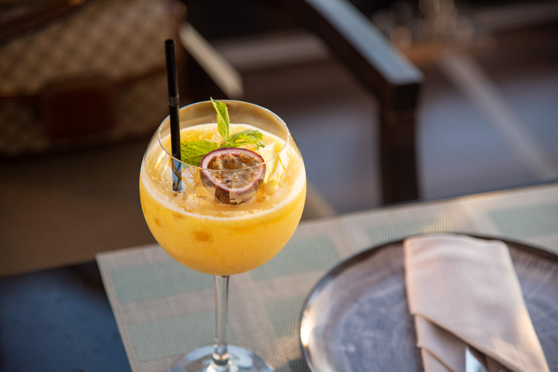 A glass of trio on a table with cutlery 