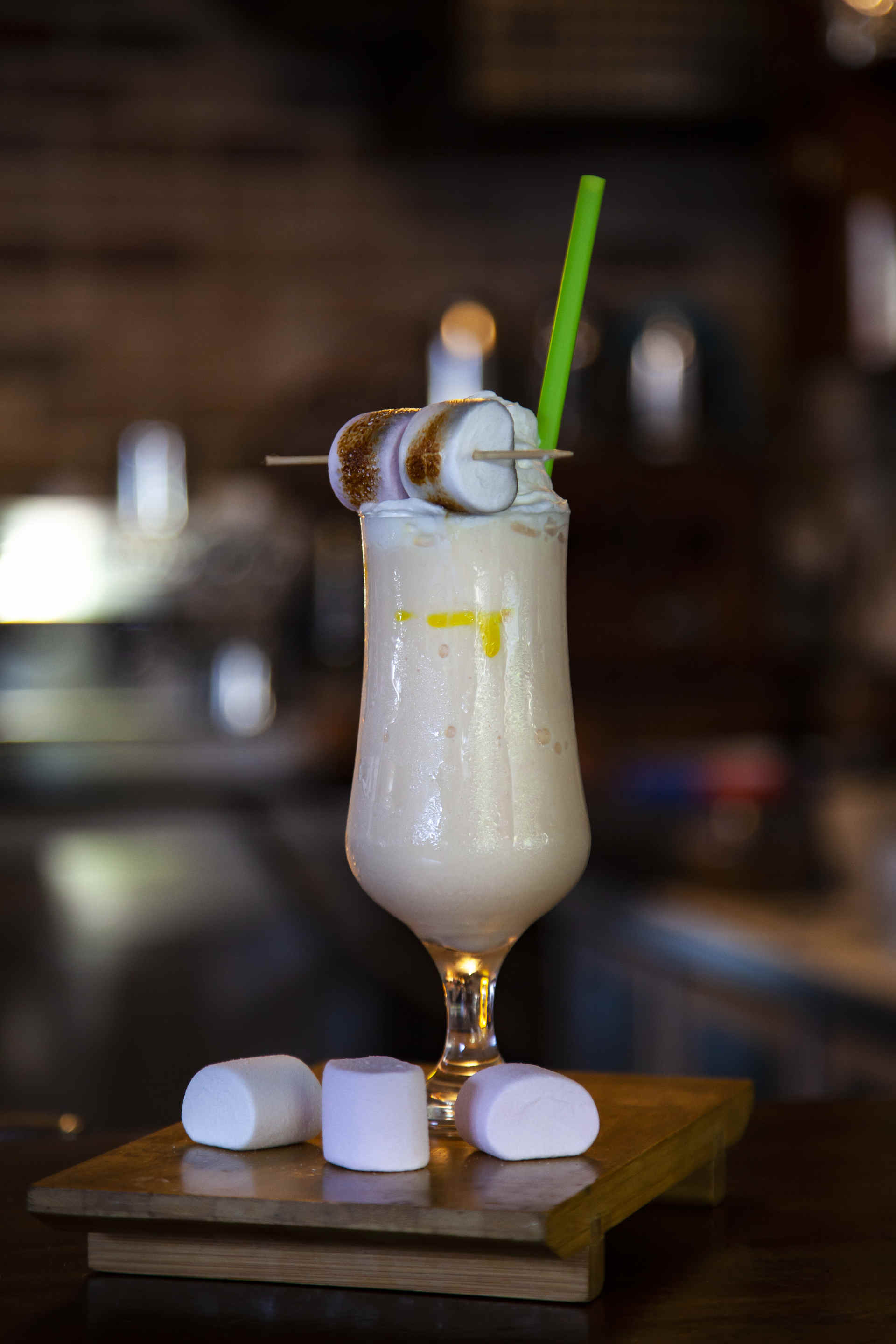 Glass of Iced Tiramisu Chocolate on a wooden board with marshmallows 