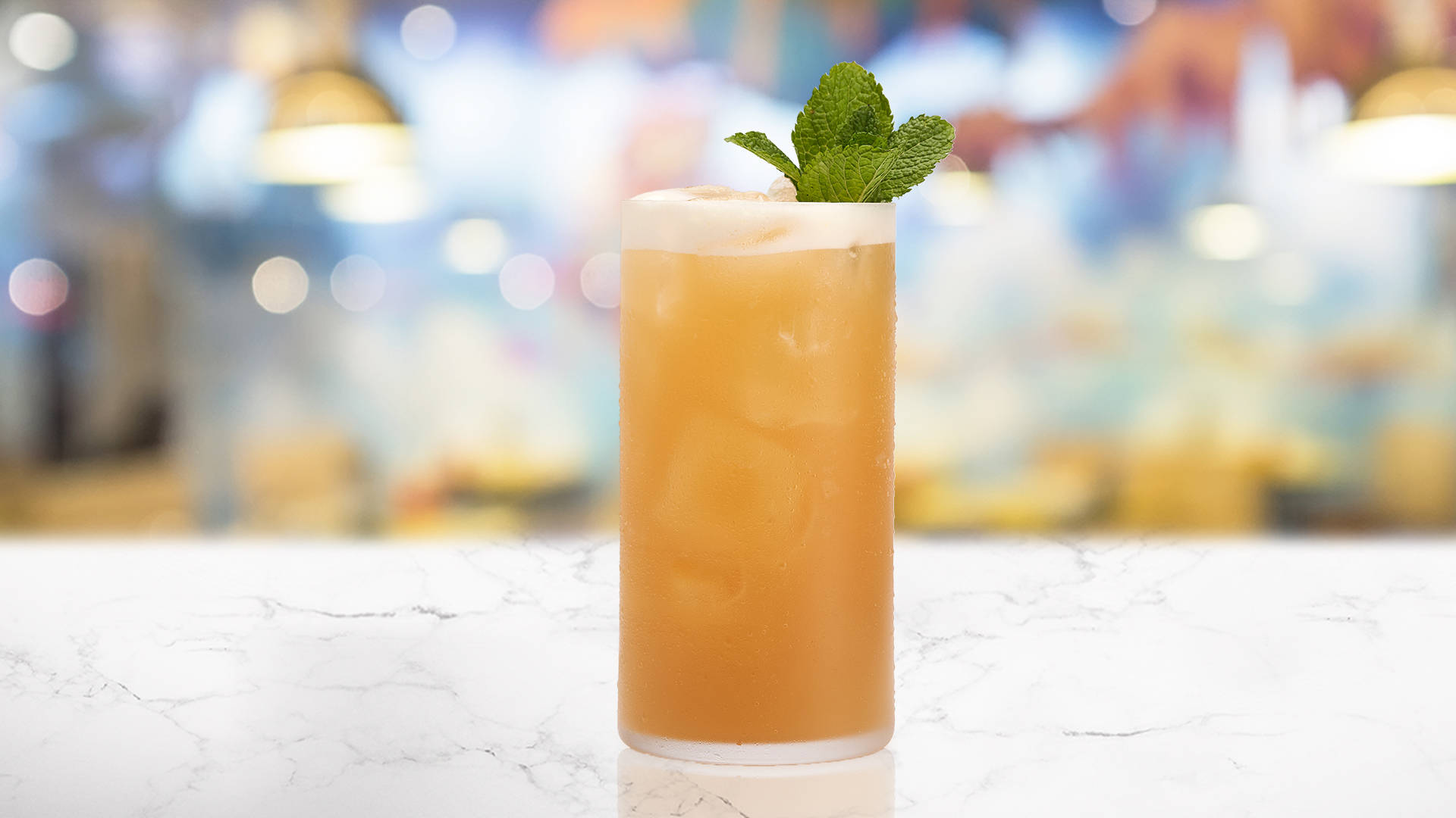 Glass of Tropicana on a marble table