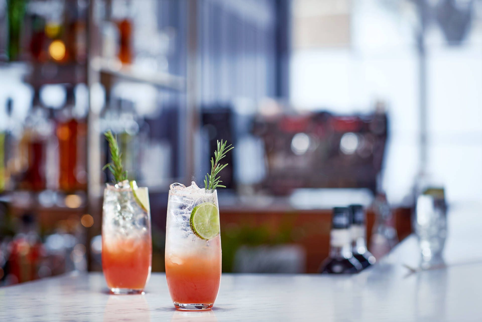 Two glasses of Passionaberry on a bar counter