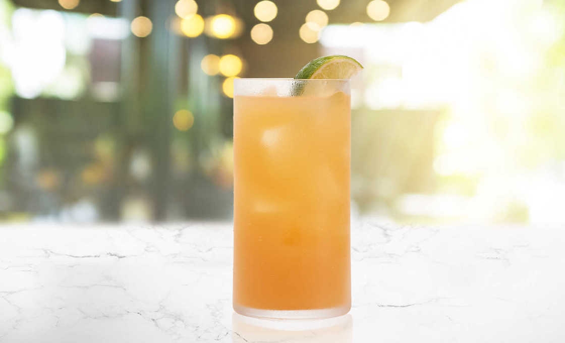 Glass of Apple Passion on a marble surface