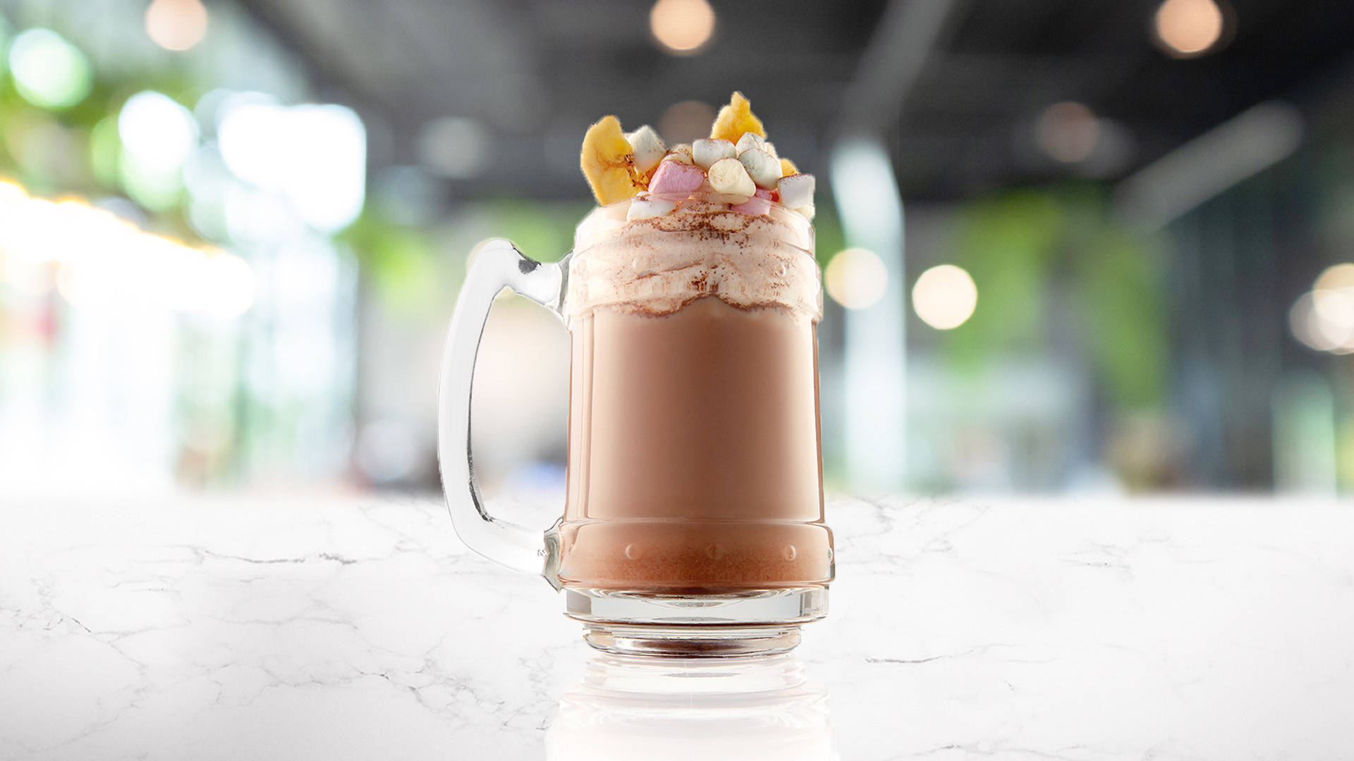 Glass of choco banana praline on a marble counter