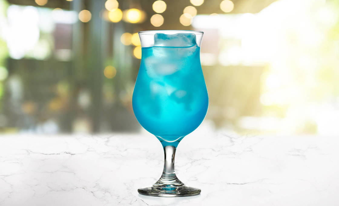 Glass of Blue Star on a marble surface