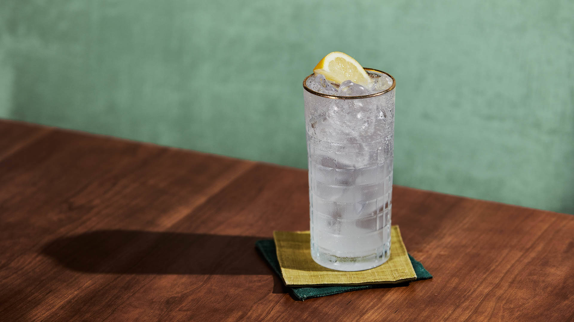 A glass of Vanilla Anise Muddle sitting on a pair of coloured mats