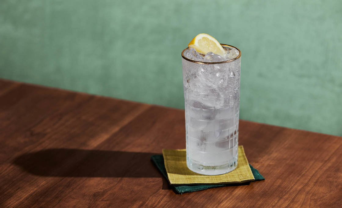 A glass of Vanilla Anise Muddle sitting on a pair of coloured mats