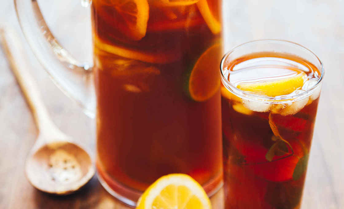 Jug and glass of Minty Mint Tea with lemon and lime