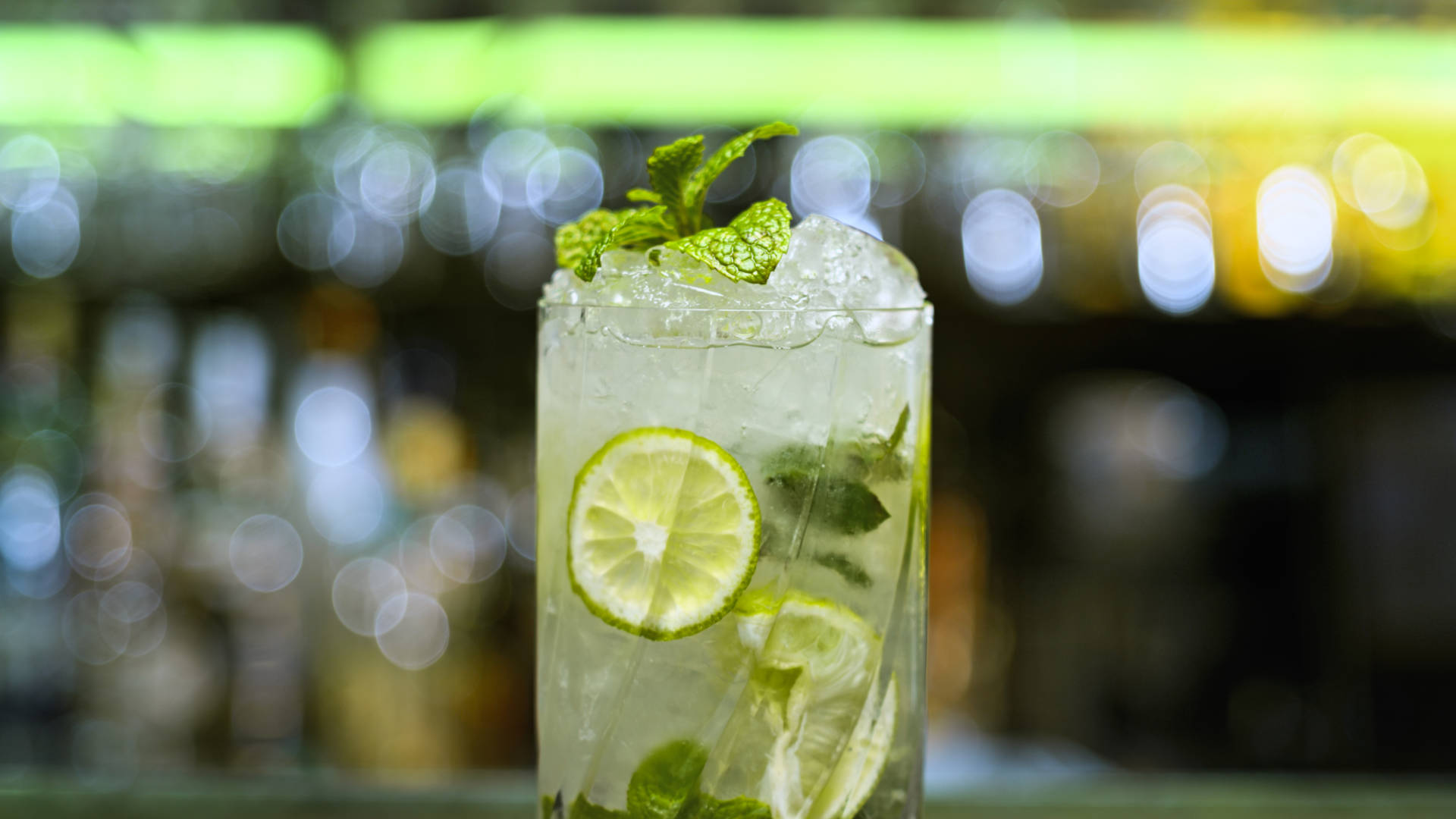 A glass of Caribbean cool with a bar out of focus behind