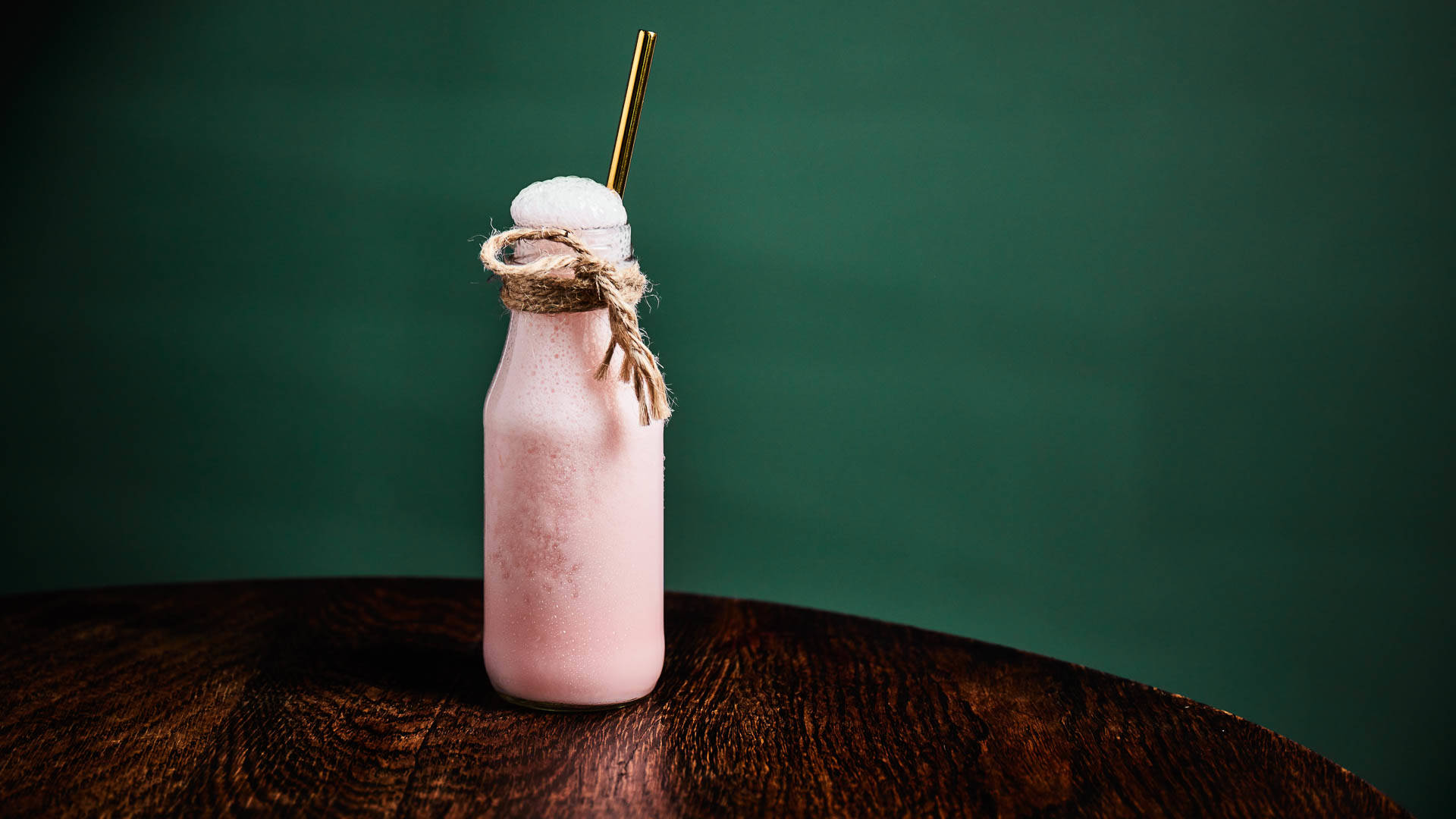 Fruity Bubble Milk on a wooden table against a green wall