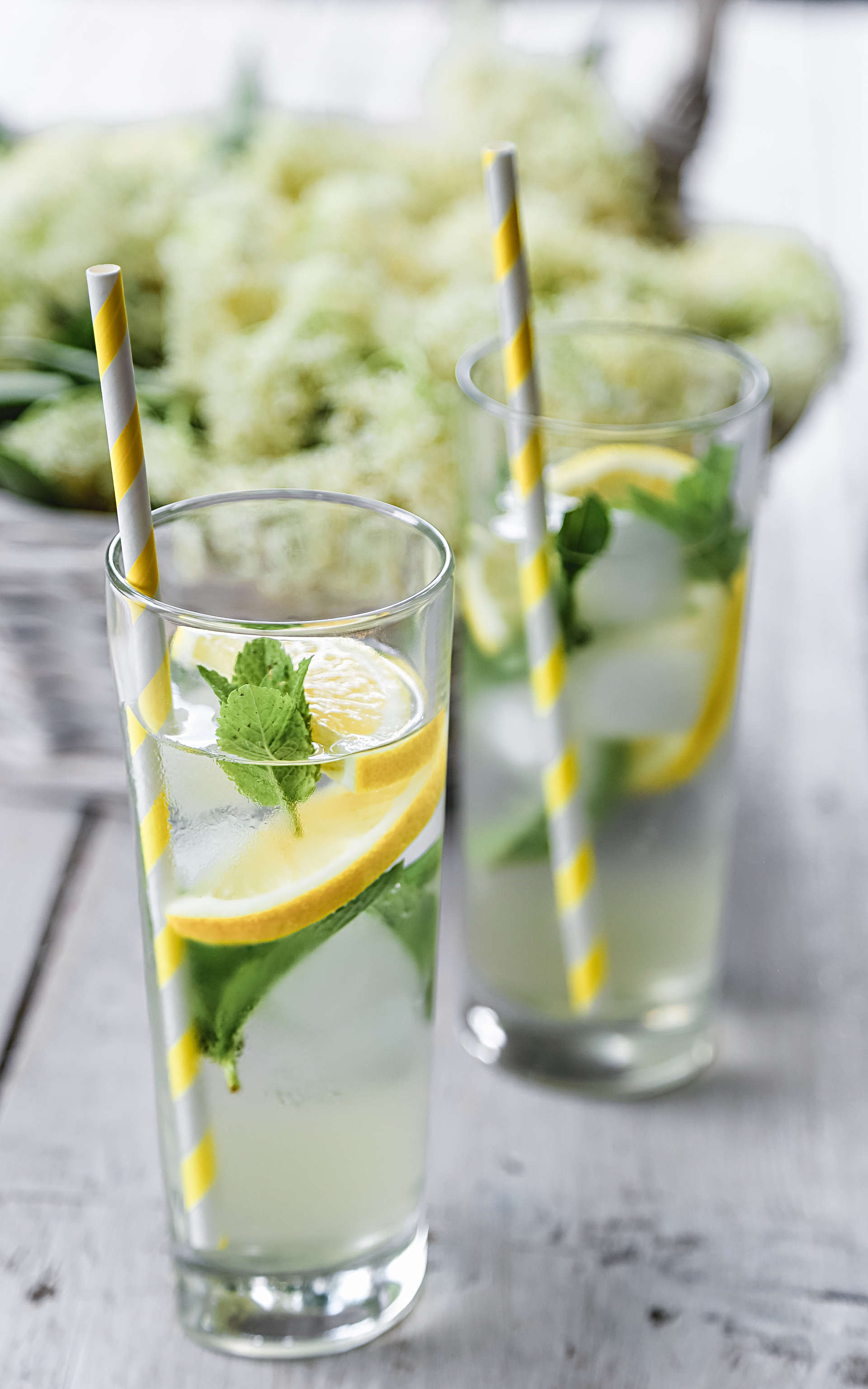two glasses of Sparkling Elderflower tea on a wooden table