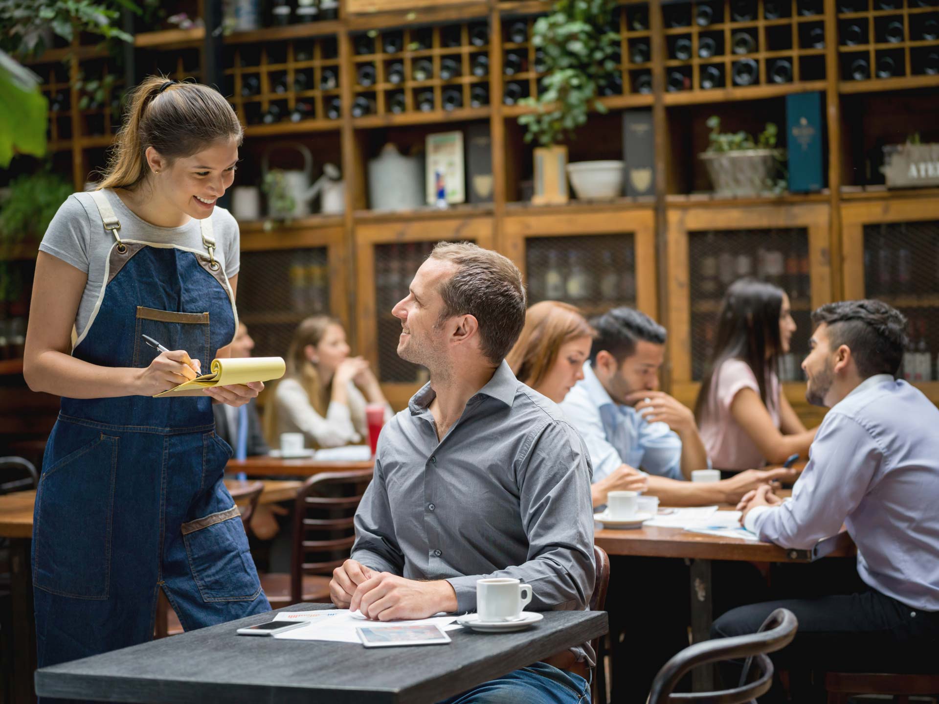 Waitress Serving Man At A Restaurant
