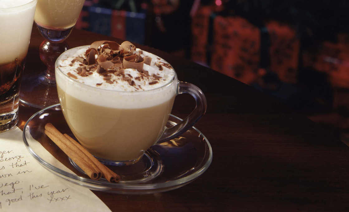 Iced Tiramisu Hard Latte on a white table cloth with a grey background