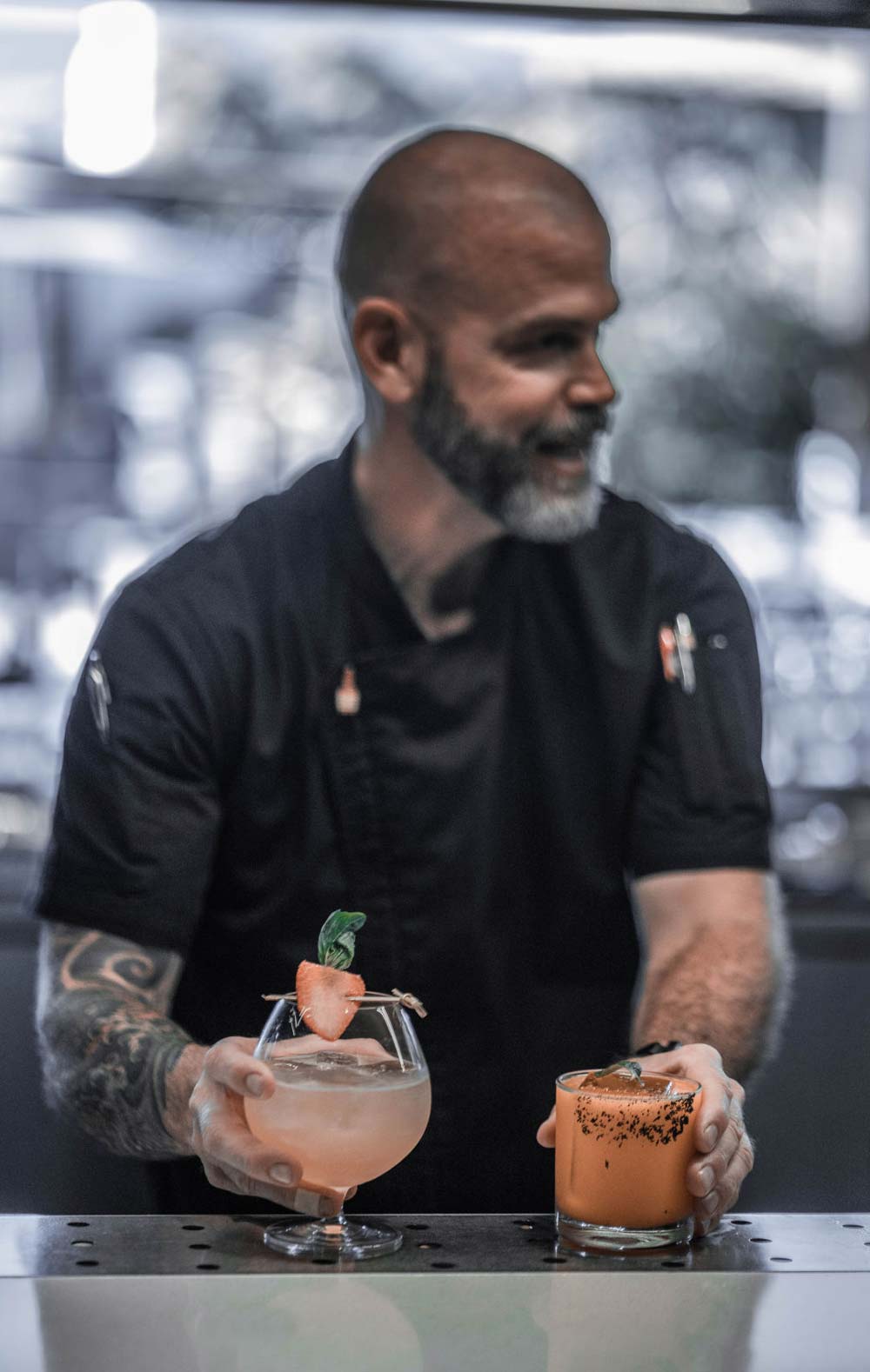 Bartender holding two drinks