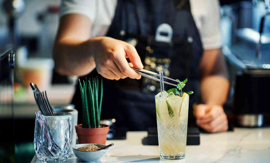 Bartender garnishing a salty lemon lemonade drink