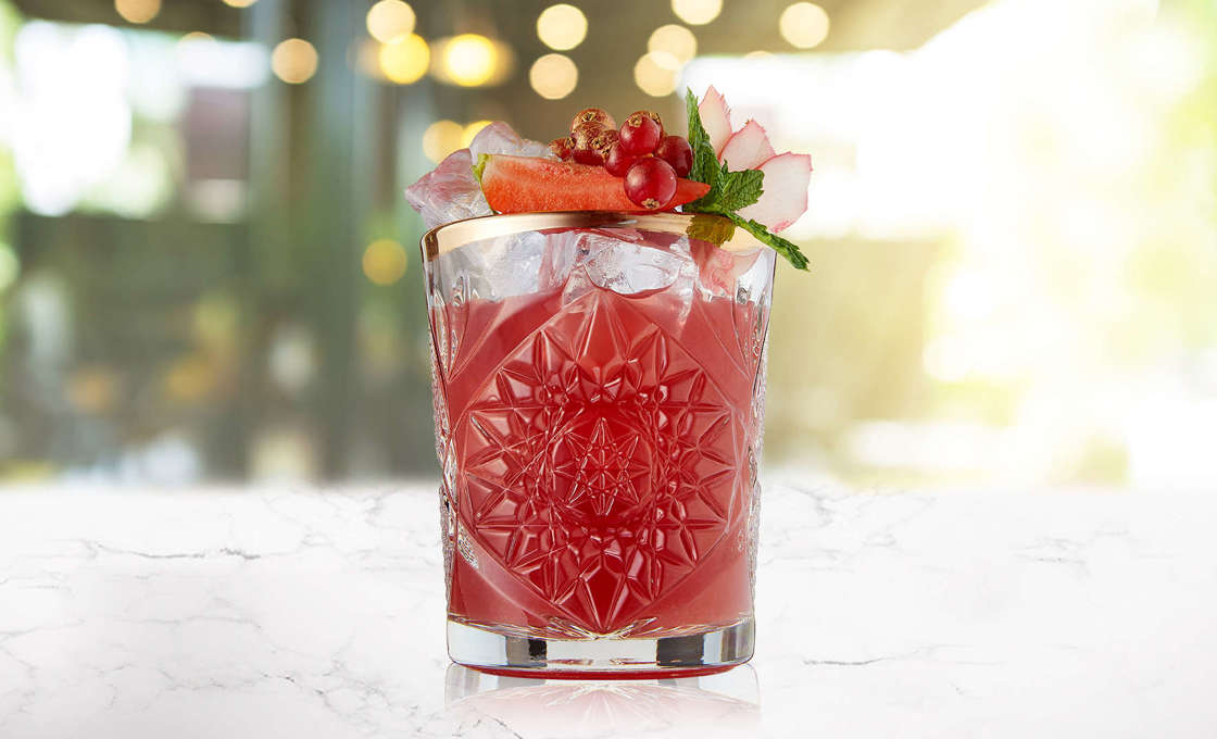Rhubarb berry punch in a detailed glass