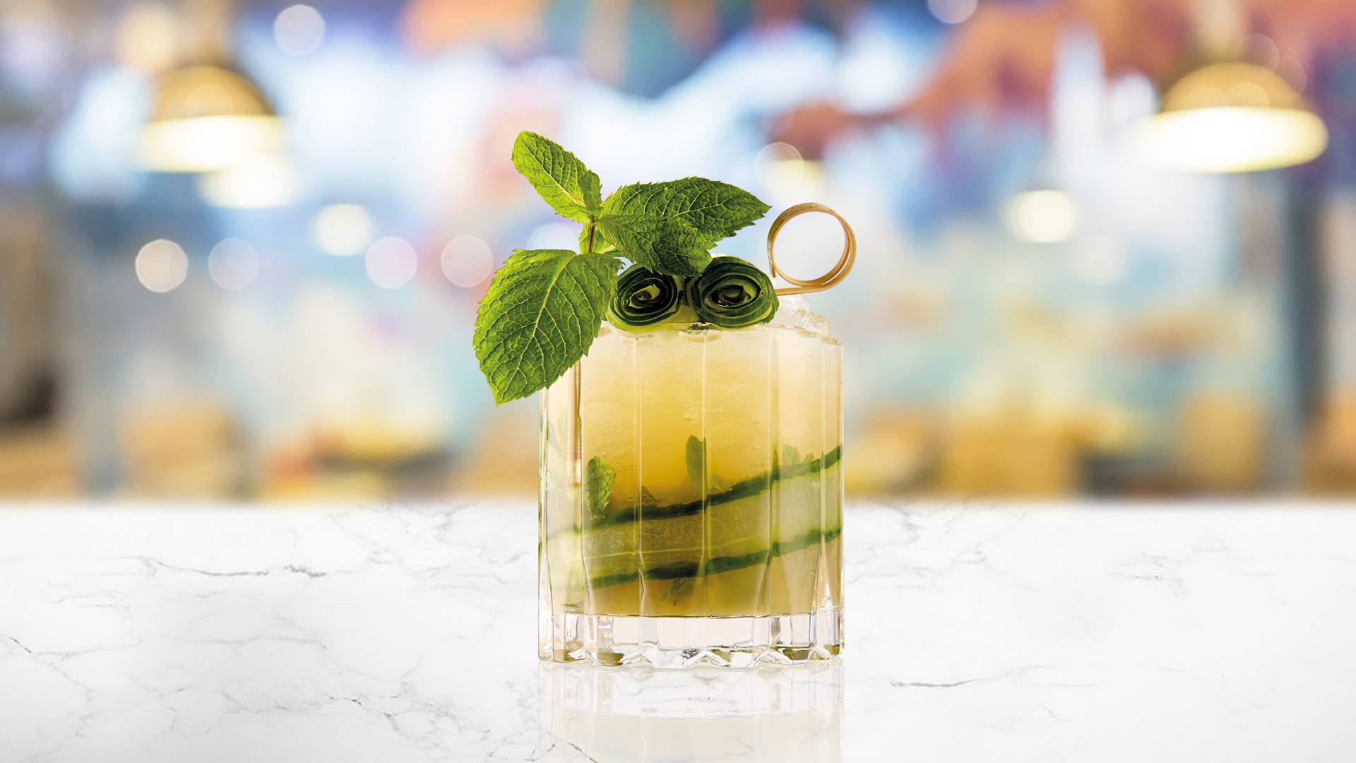 Glass of Green Tea & Cucumber Fizz on a marble surface