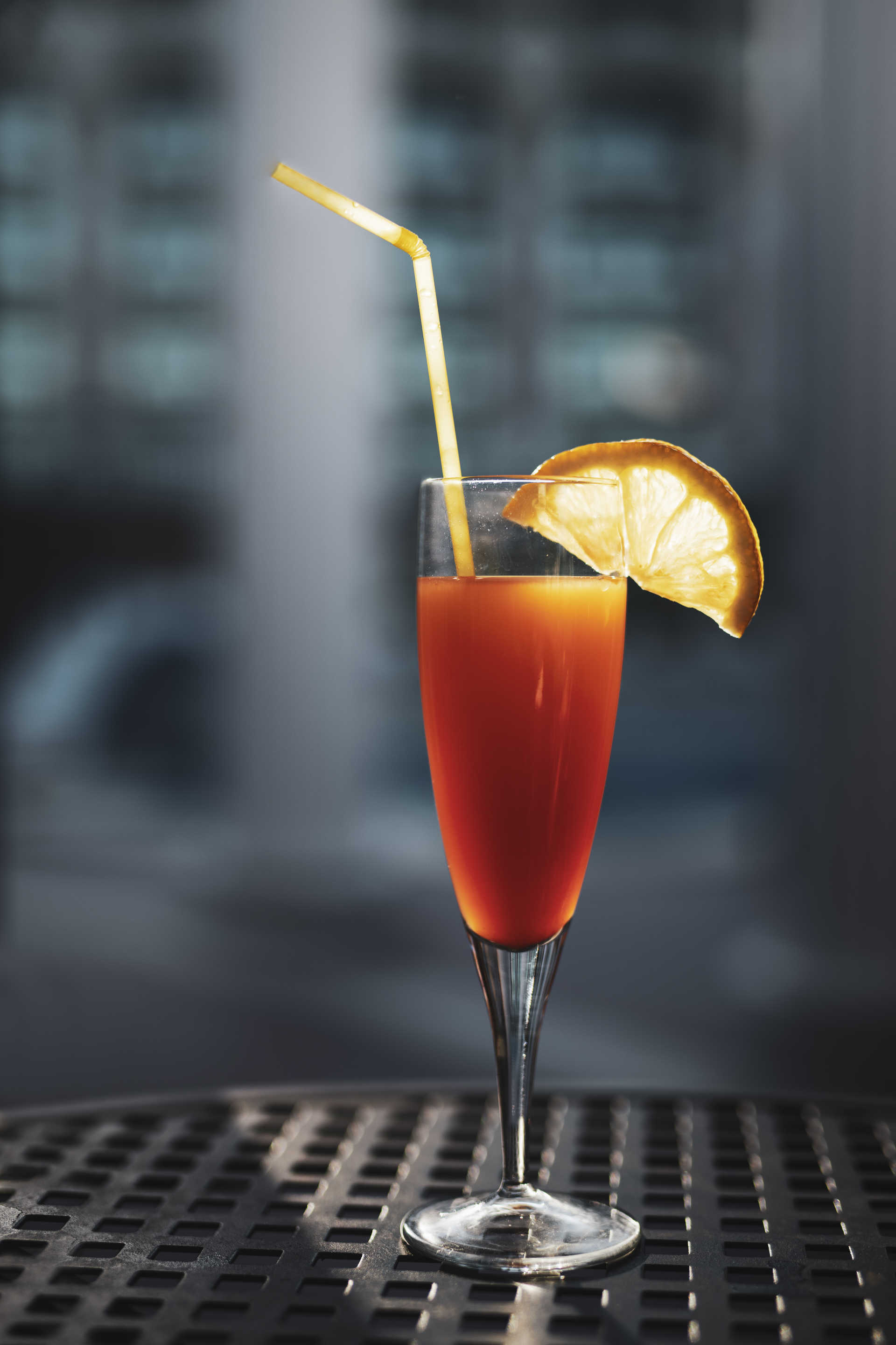 Grenadine Fruit Fizz in a slim glass on a metal table