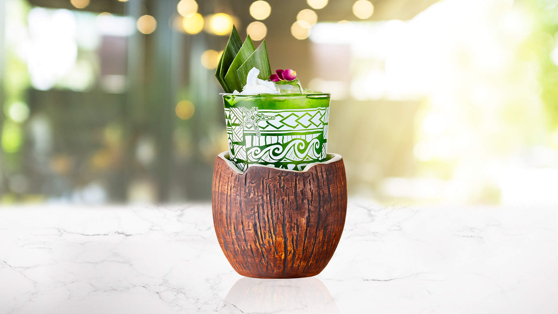 Glass of pandan cooler in a coconut