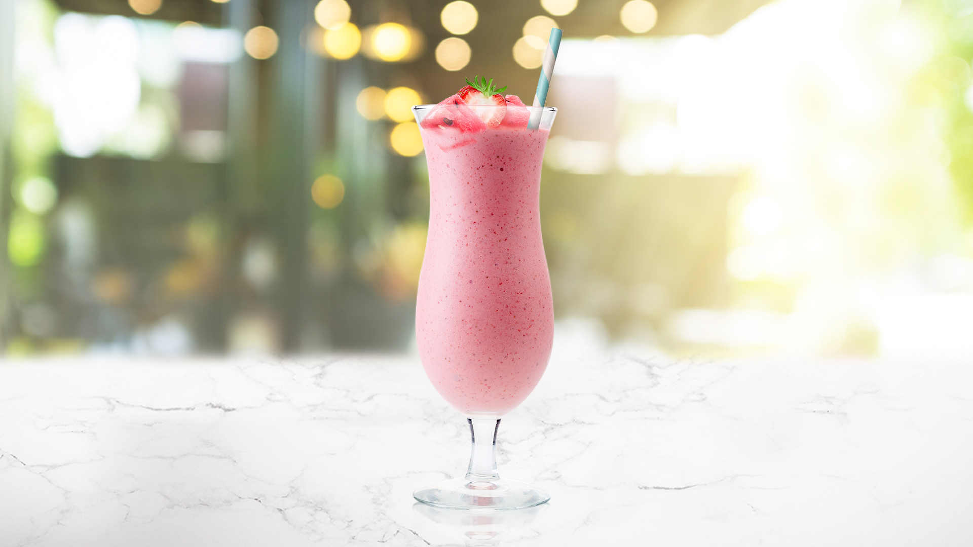 A glass of Fan Club on a table outside