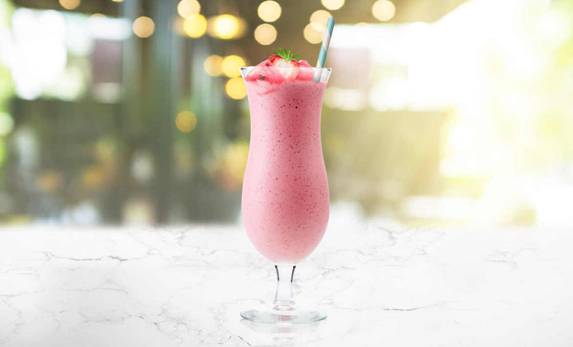 A glass of Fan Club on a table outside