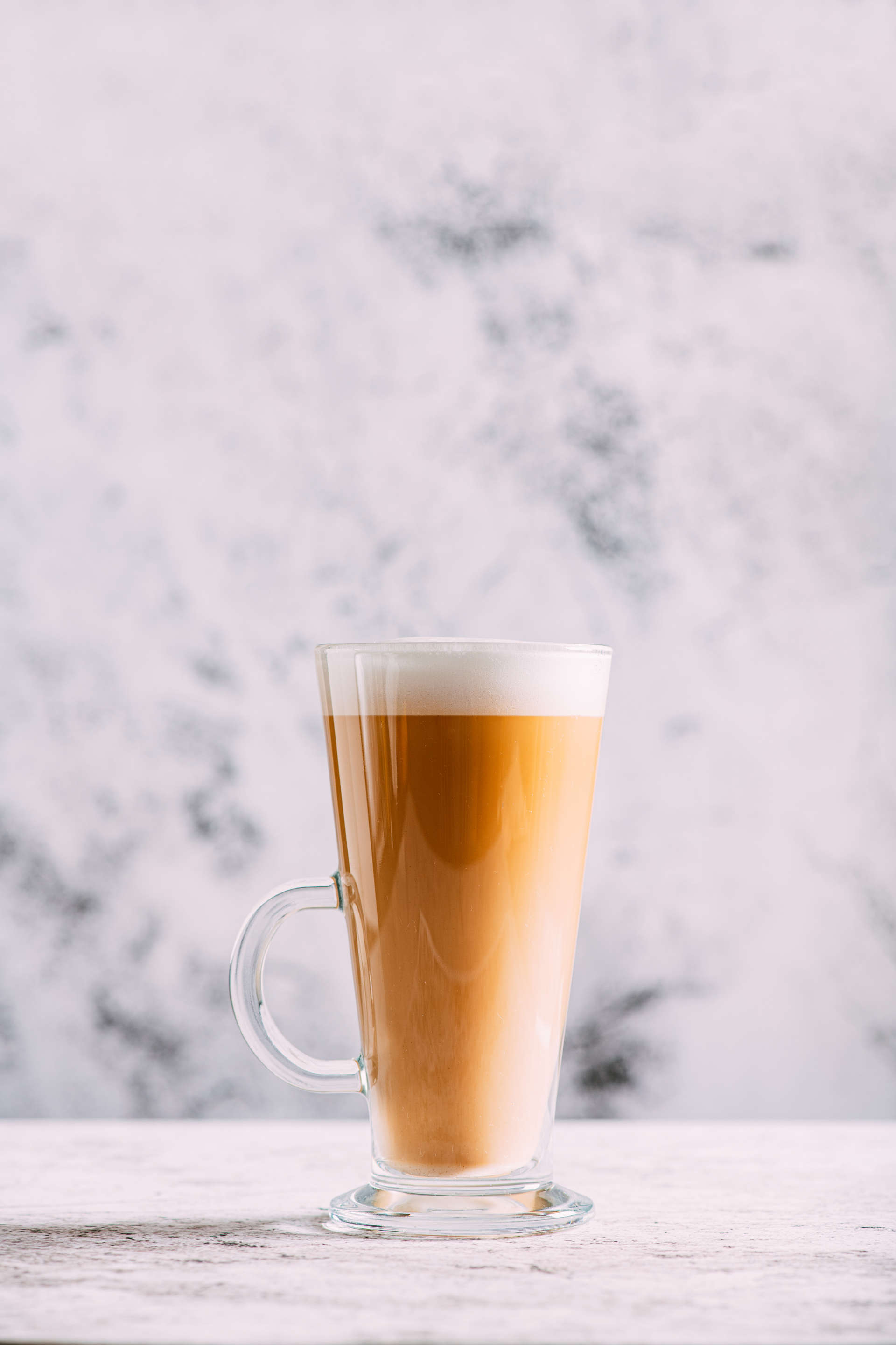 glass of Vanillaccino on a stone surface with a marble background
