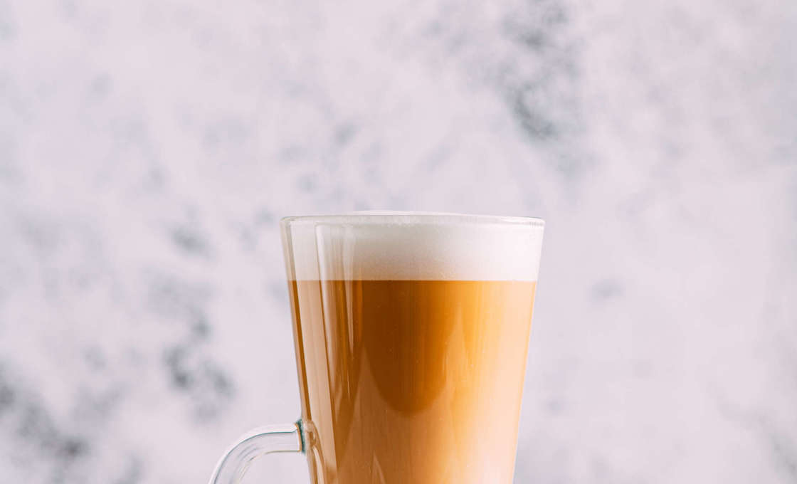 glass of Vanillaccino on a stone surface with a marble background