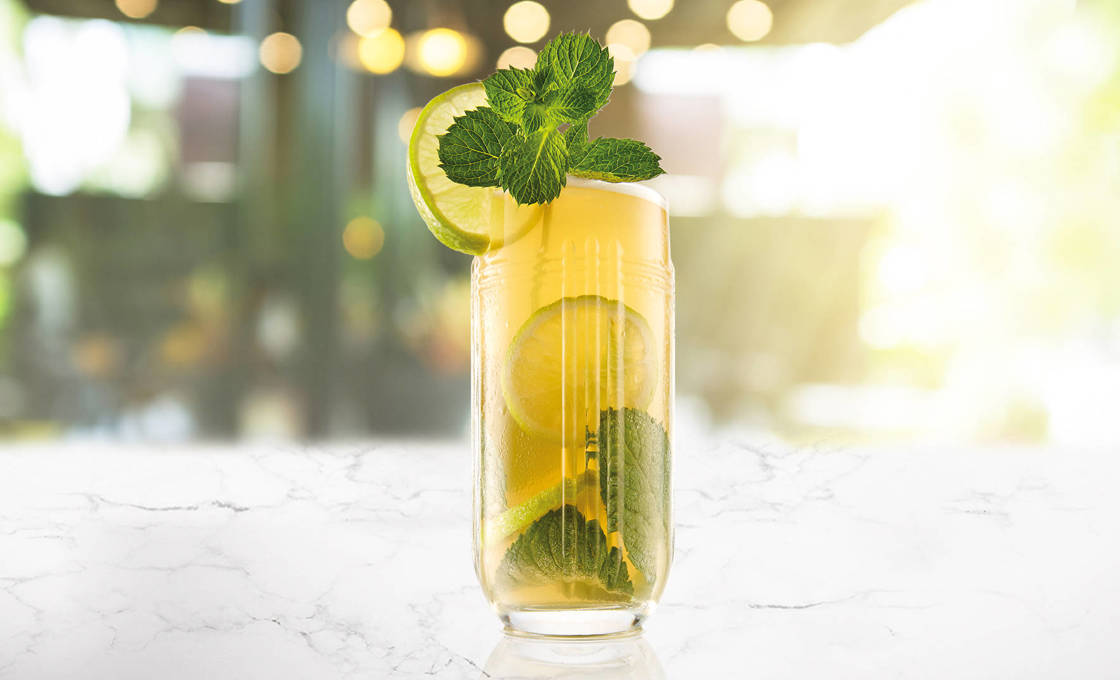 Glass of Sencha Green Iced Tea on a marble surface