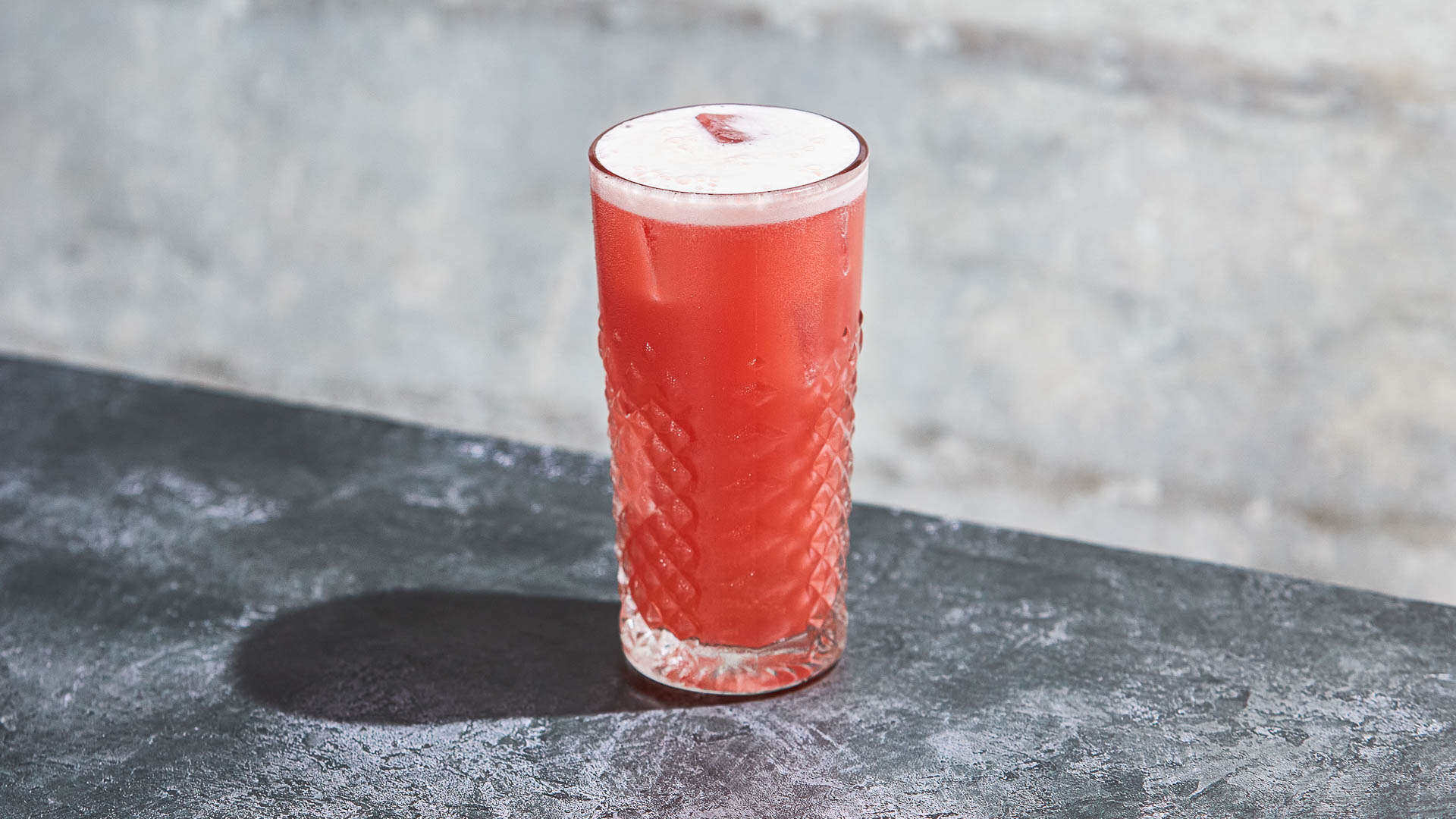 A glass of Forest Touch on a granite surface