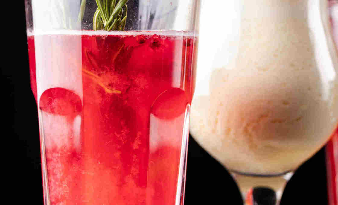 Glass of Pomegranate Lemonade with another drink in the background