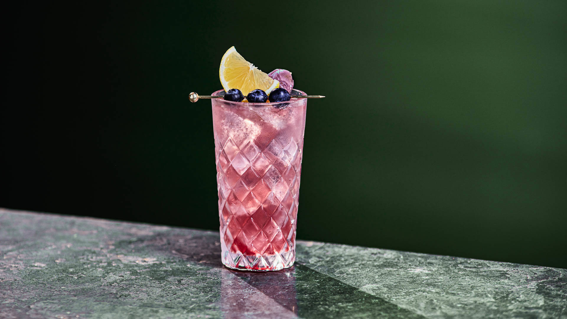Glass of yuzu blu on a granite surface