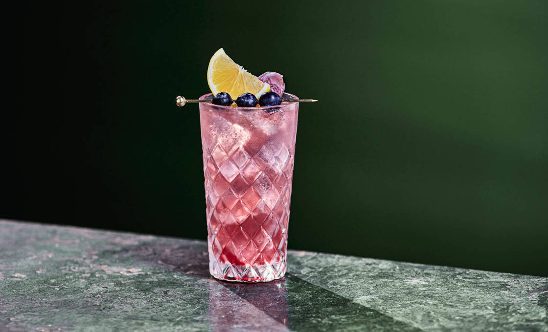Glass of yuzu blu on a granite surface